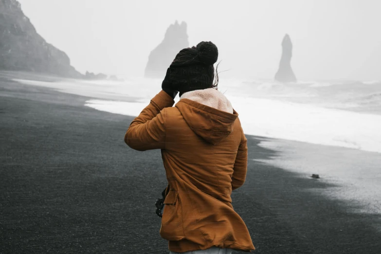 someone in the cold looking at two large rock formations