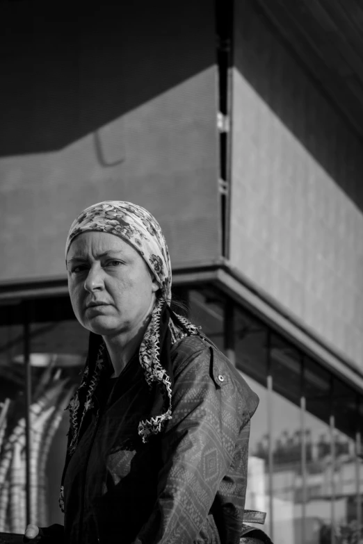 black and white pograph of a woman in front of a building