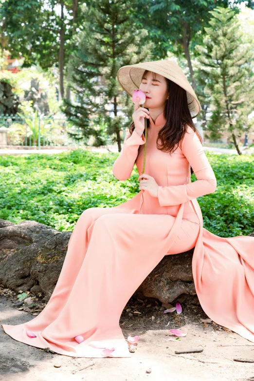 a woman is posing while wearing a hat and dress