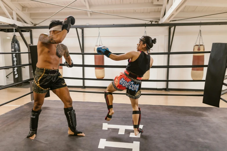 two boxers in their boxing class kick punches