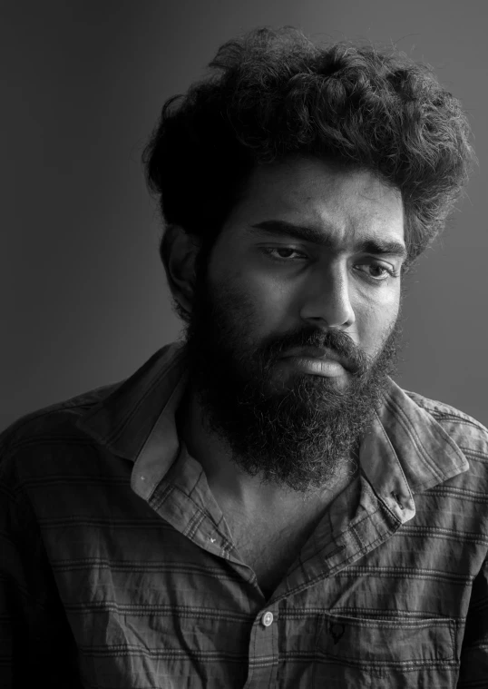 man with long beard wearing striped shirt in black and white po