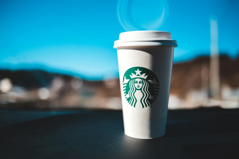 a starbucks cup with steam rising from it