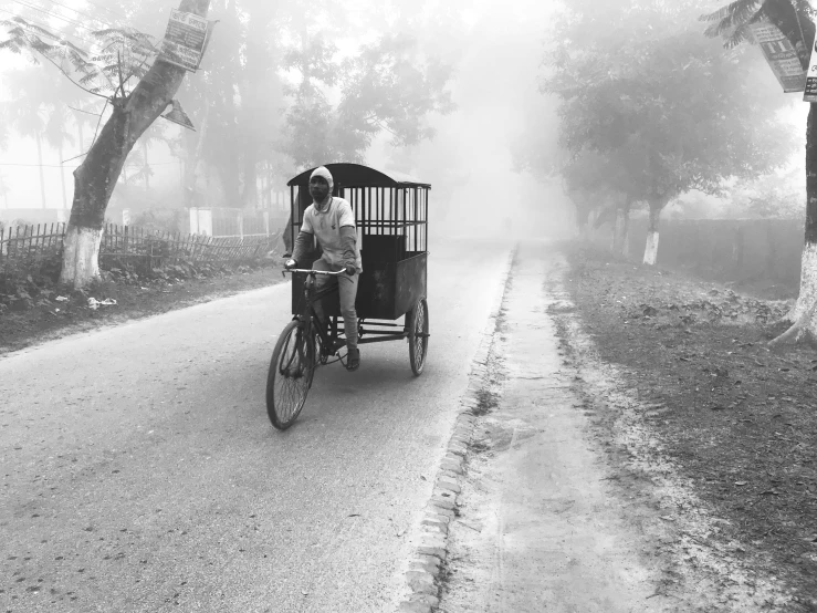 an old man is riding a cart on a street