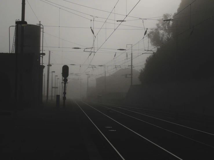 a train station on a foggy, overcast day