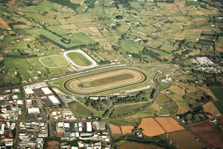 an aerial view of a horse track running along its track