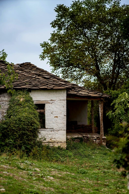 an abandoned building with an old roof and an open window