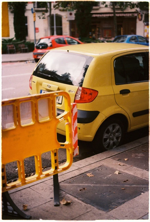 a parking meter that is next to a yellow car