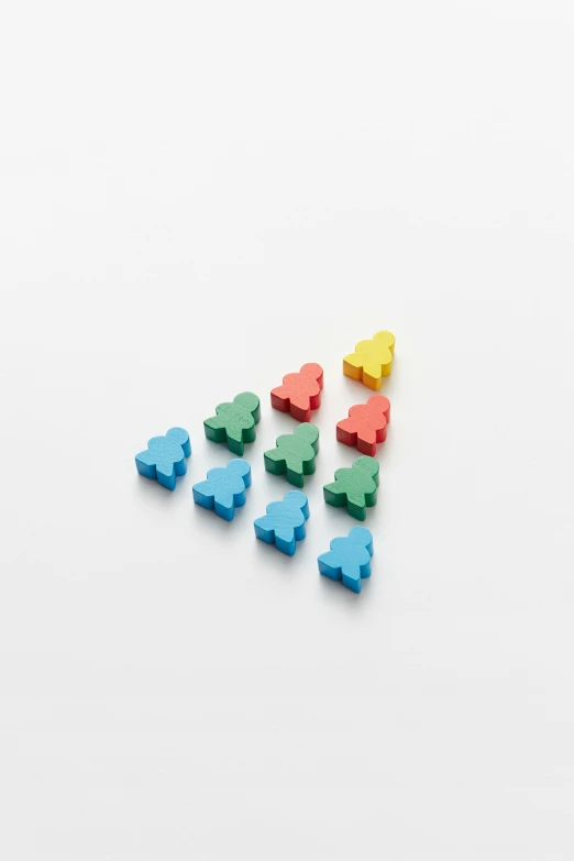 small colorful colored plastic shapes laying on a white surface