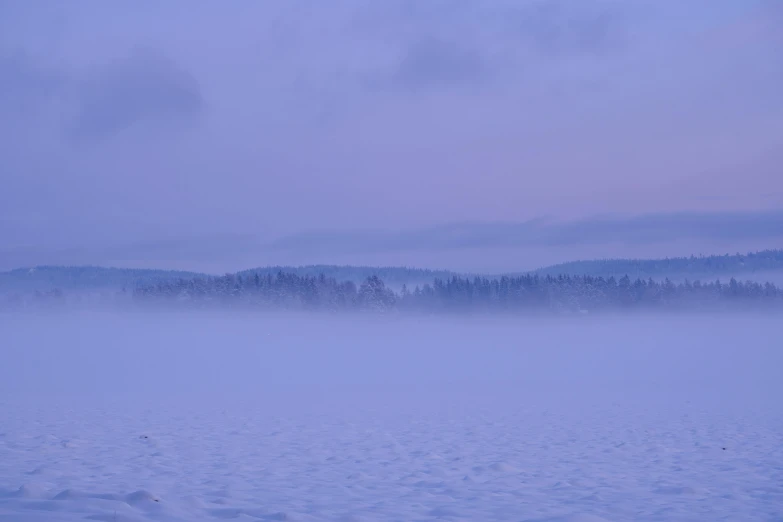 a lone plane traveling over a snowy field