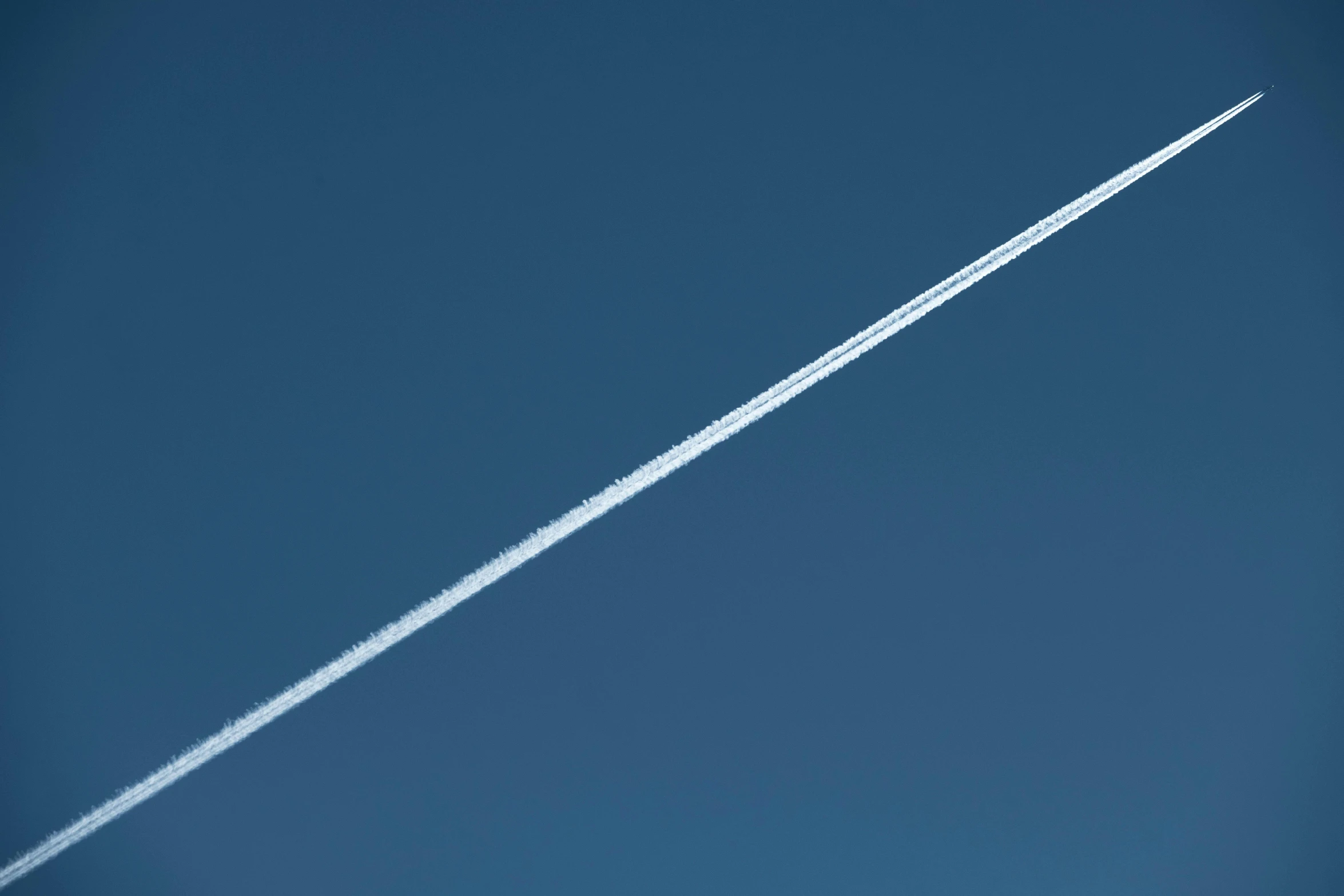 a airplane flying in the sky with its long wing