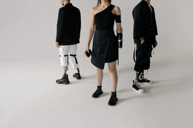 three models with black outfits looking in different directions