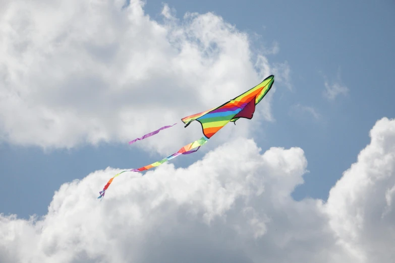 colorful kites flying against an overcast sky