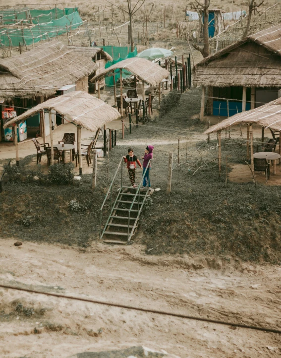 two men are standing outside near an overcast day