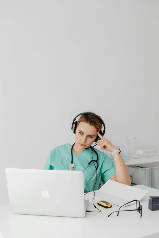 a woman sitting in front of a laptop computer