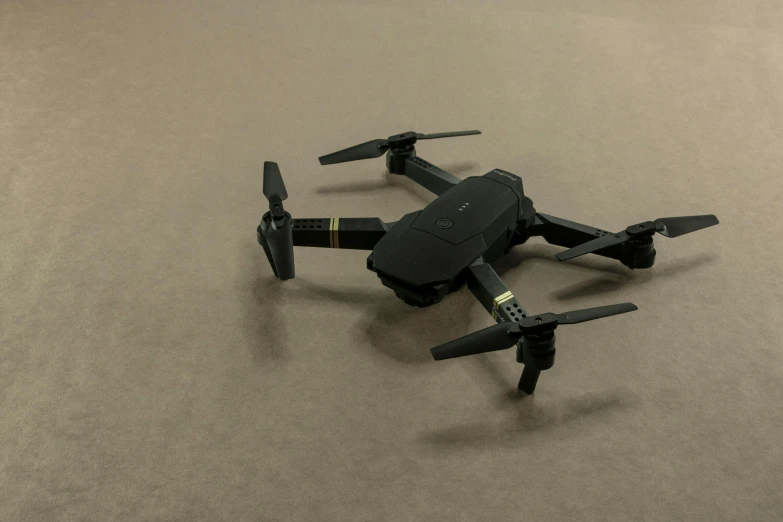 a large remote controlled flying on top of a gray surface