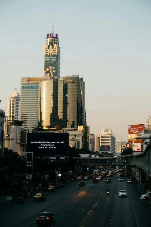 an empty road with cars and buildings in the background