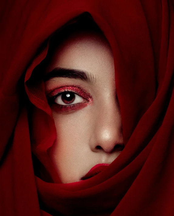 the woman is covered by a blanket with red eyes