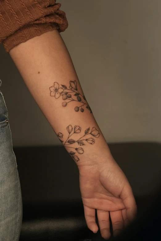 a flowery wrist tattoo is on a person