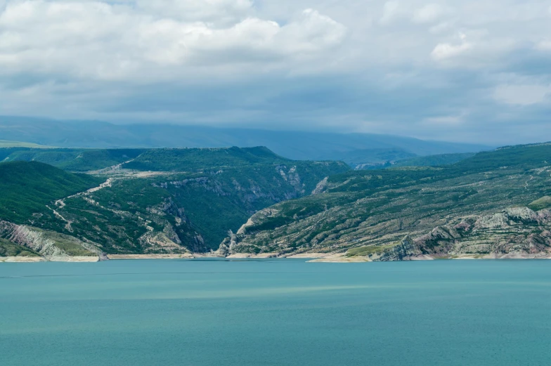 a body of water with a mountain in the background