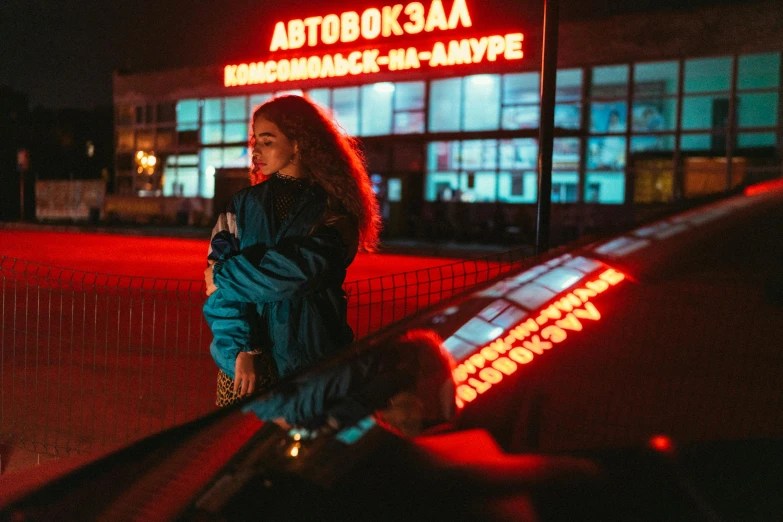 a woman looking out from behind a fence