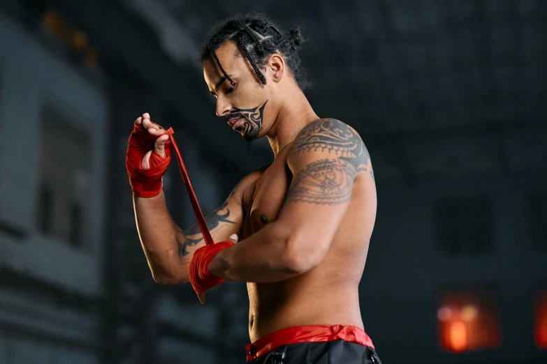 a man with tattoos standing in a gym