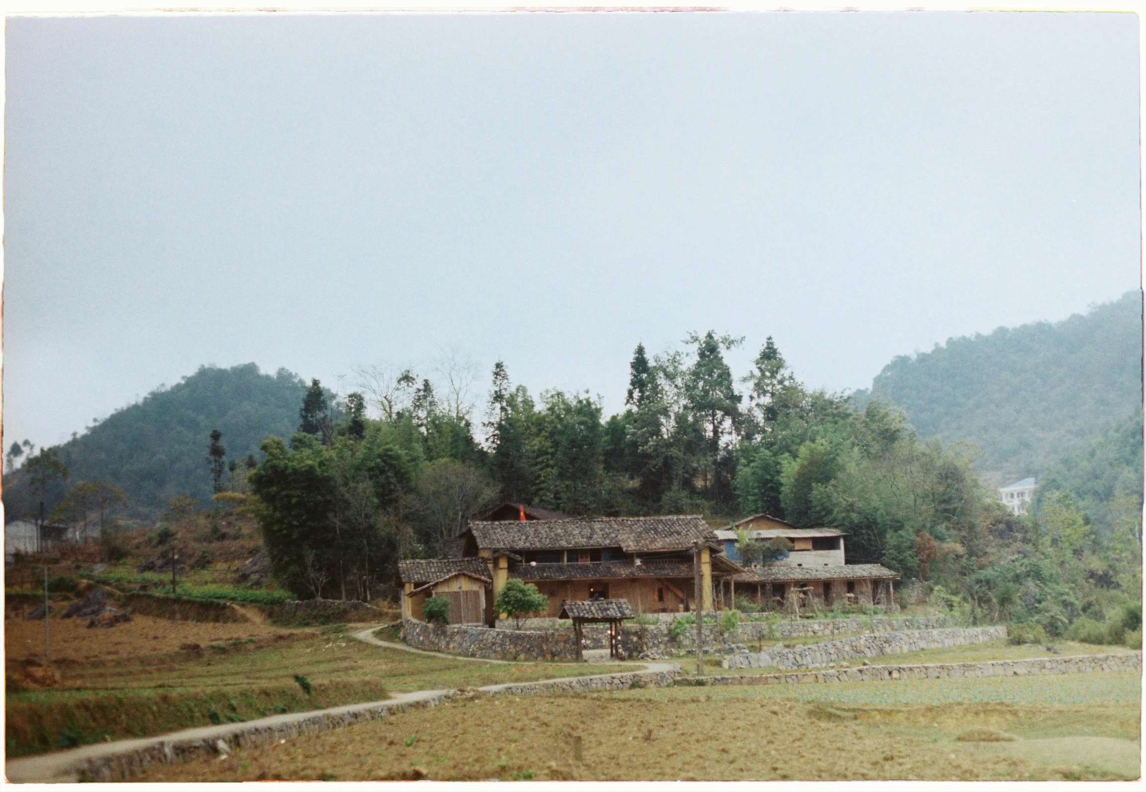 this is an old cabin with mountains in the background