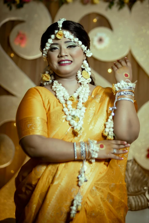 a woman wearing pearls and jewelry in front of a floral display