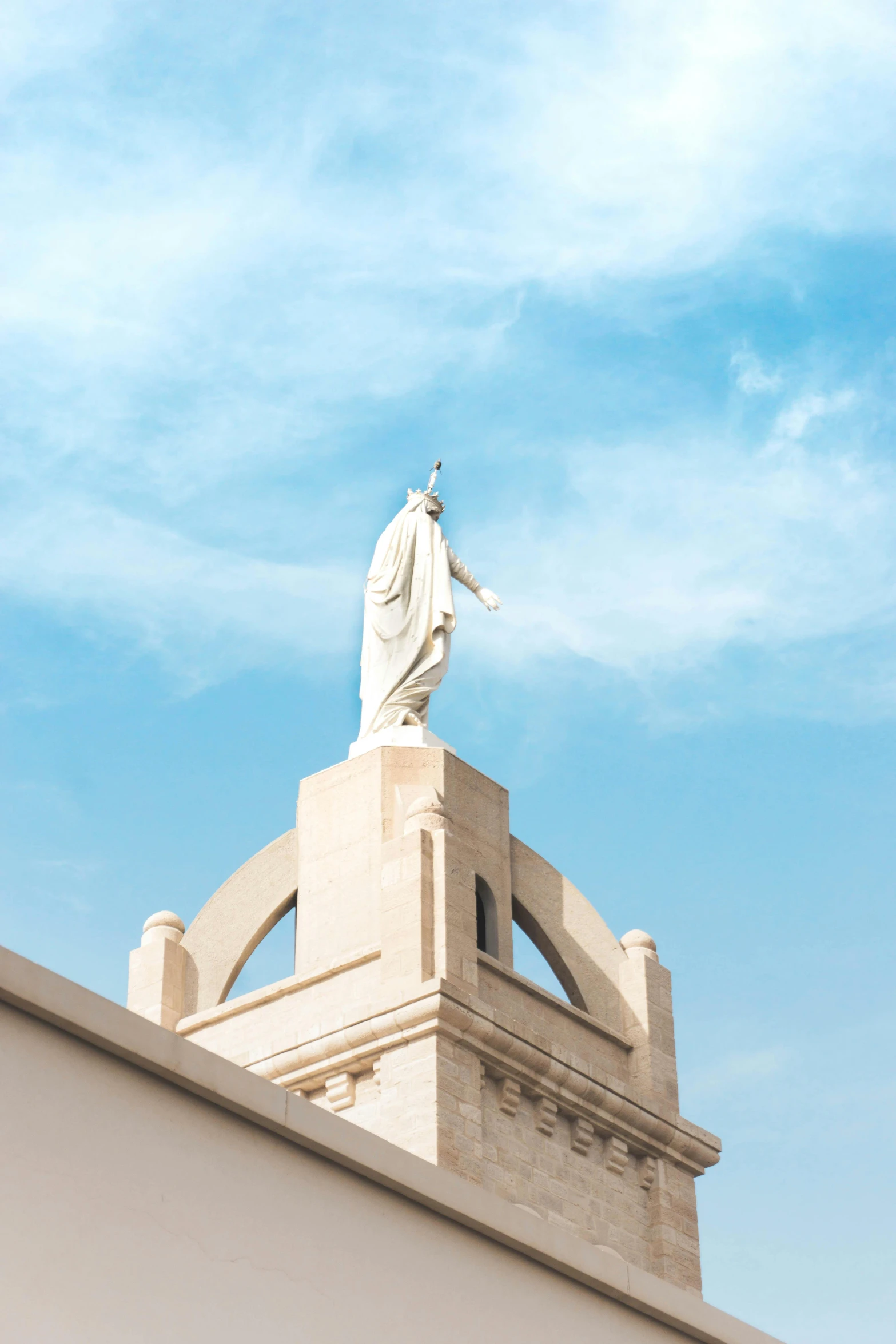 the statue is shown atop a white building