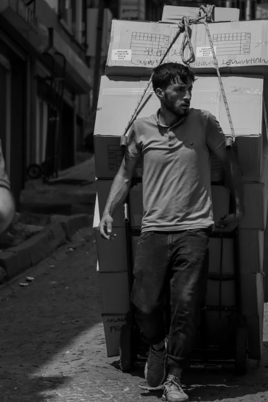 a man is standing by stack of boxes