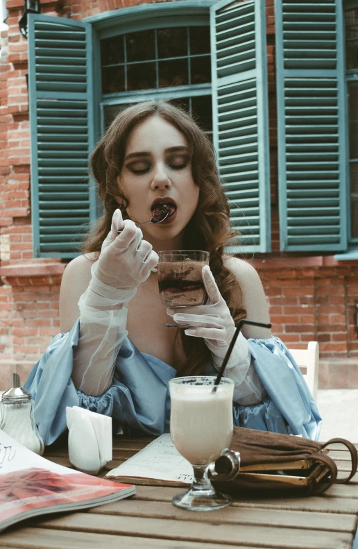 a girl eating a donut and drinking milk