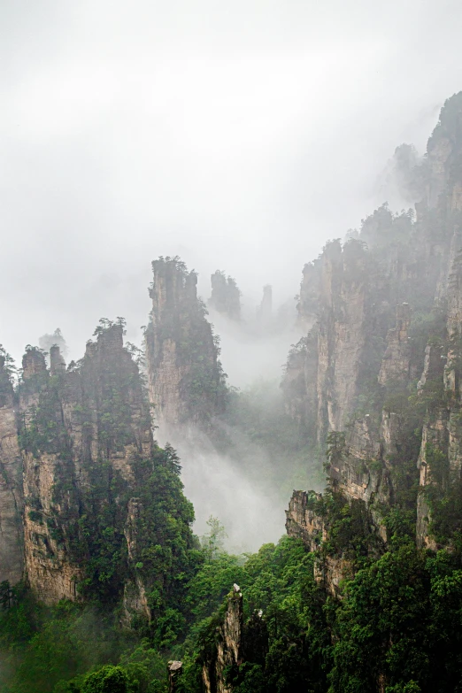 a small mountain peak with a waterfall in the distance