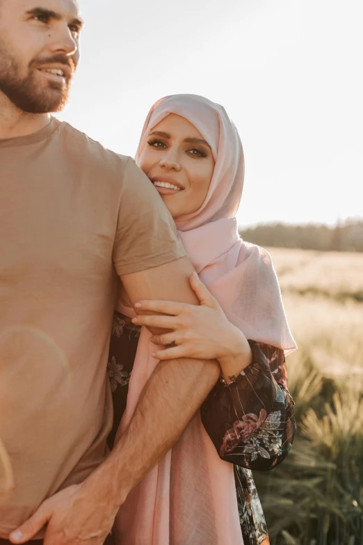 young adult couple in desert setting emcing each other