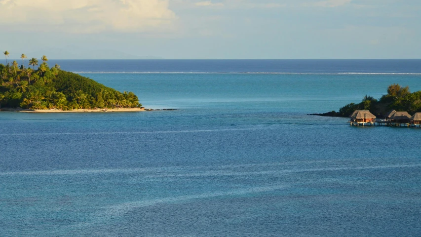 a small island surrounded by clear blue water