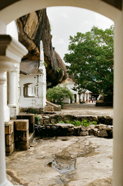 a house in the middle of a stone courtyard