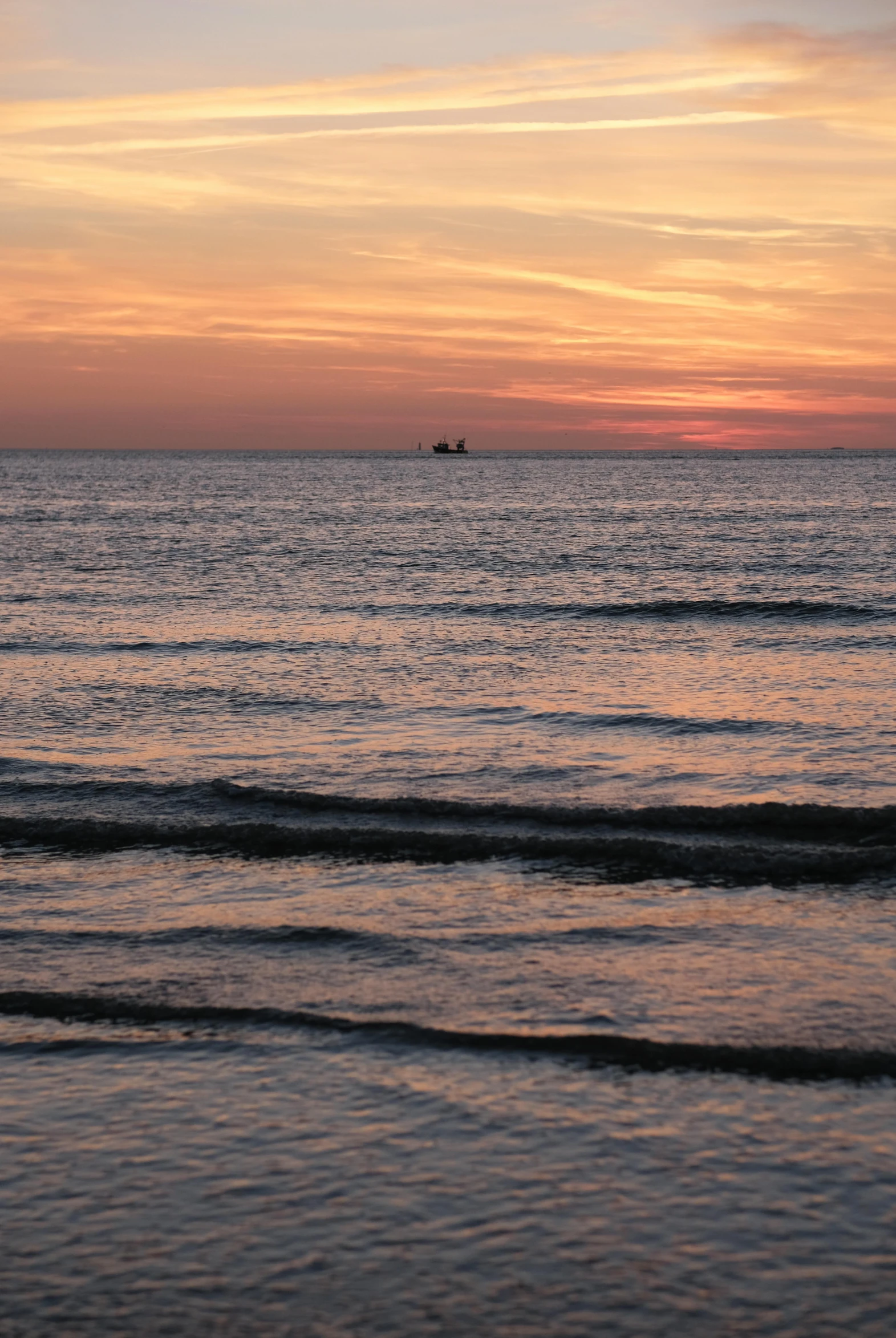 there is an ocean view at sunset with a boat in the water