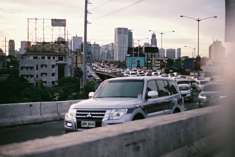 a city highway filled with cars under an overpass