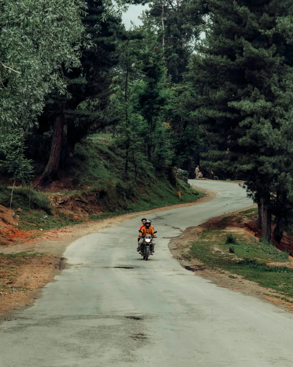 a person riding a bike on a rural road