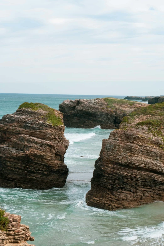 a very big pretty looking rocky outcropping by the ocean