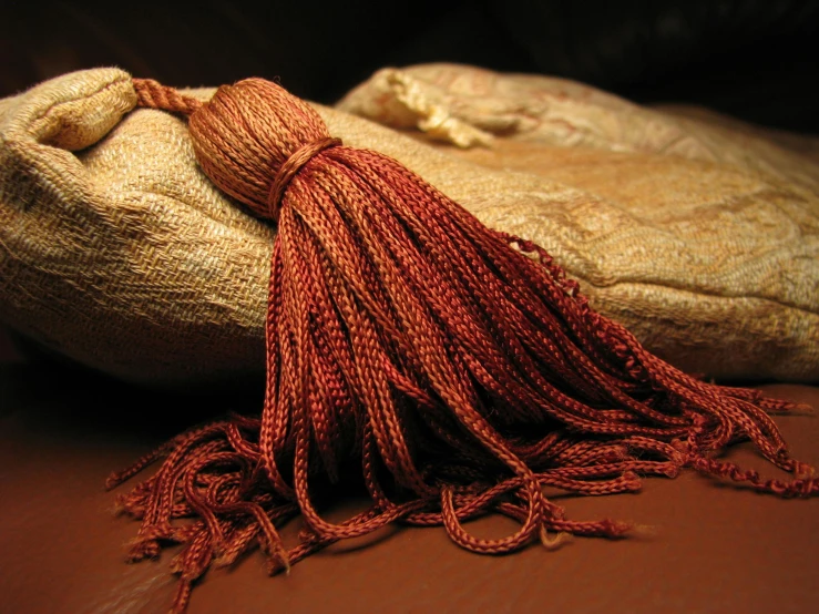 a tasselled pouch on a brown surface