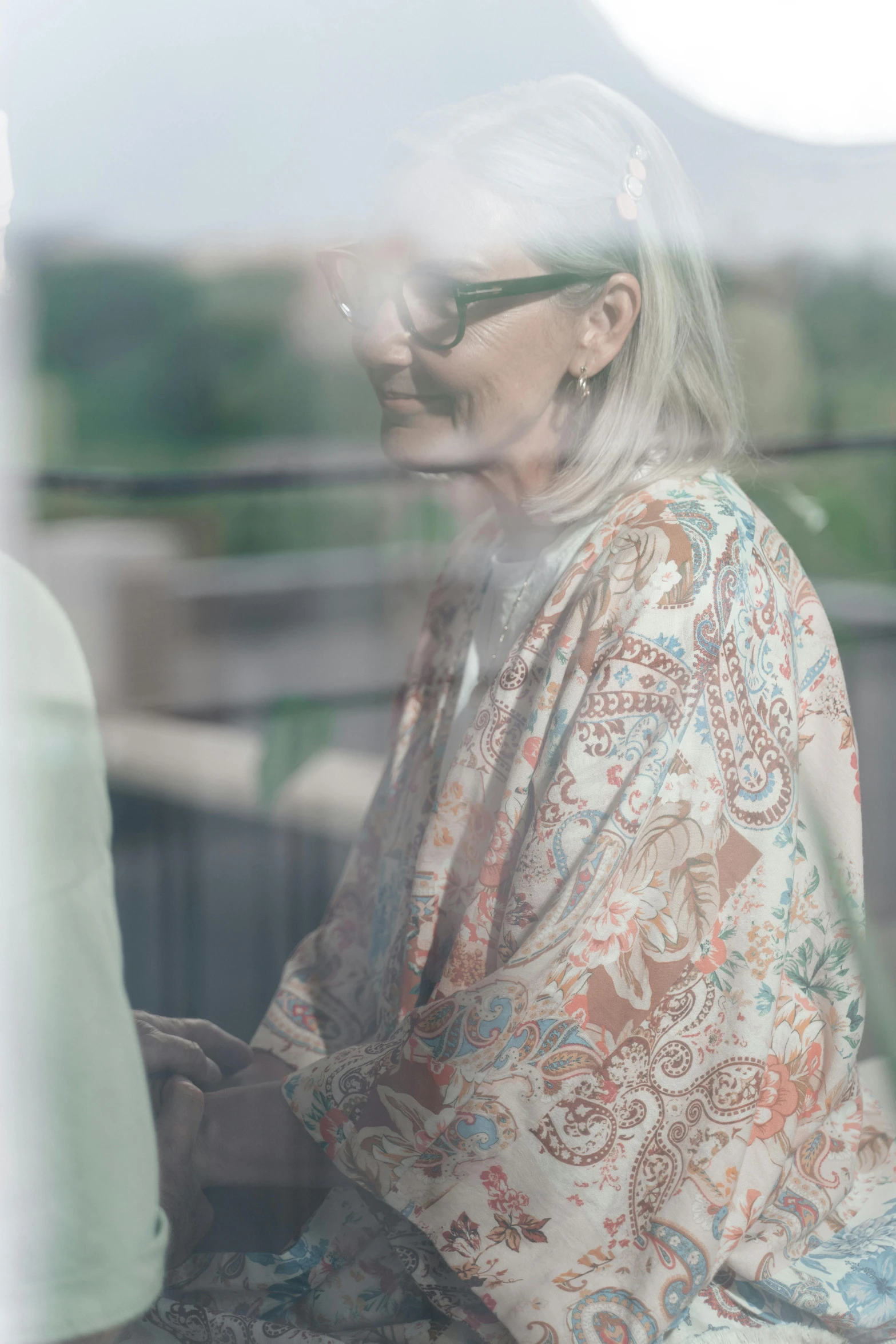 a woman sitting on a bench with her head turned to the side