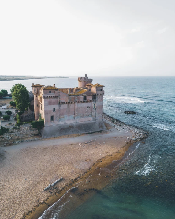 an old building in front of the ocean