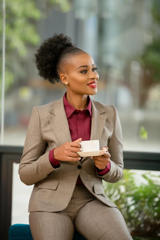 a woman sitting at a table with a cup of coffee