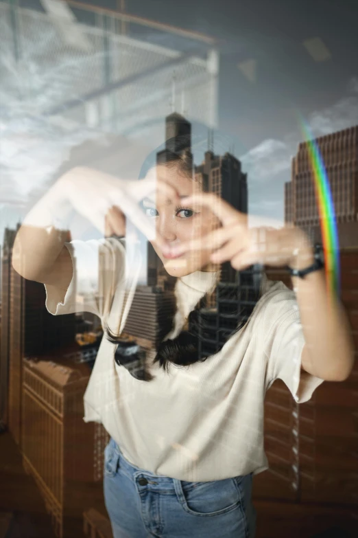 a woman poses while looking into a glass window