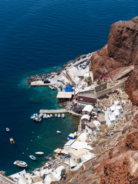 boats parked next to a shoreline in the water