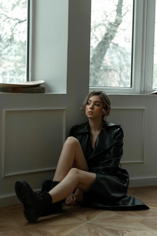 a person in a black dress is sitting on the ground