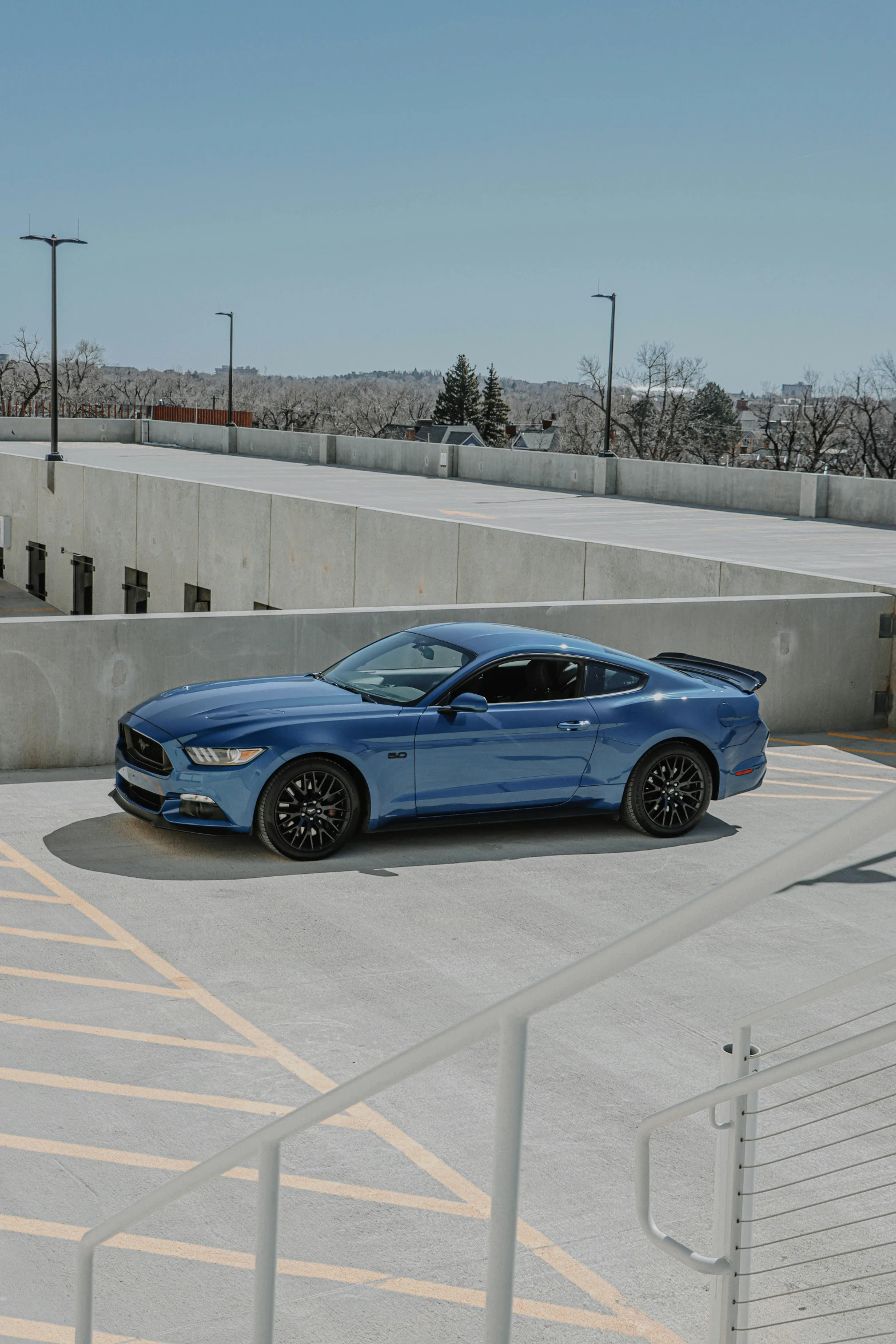 the blue sport car is parked in the parking lot