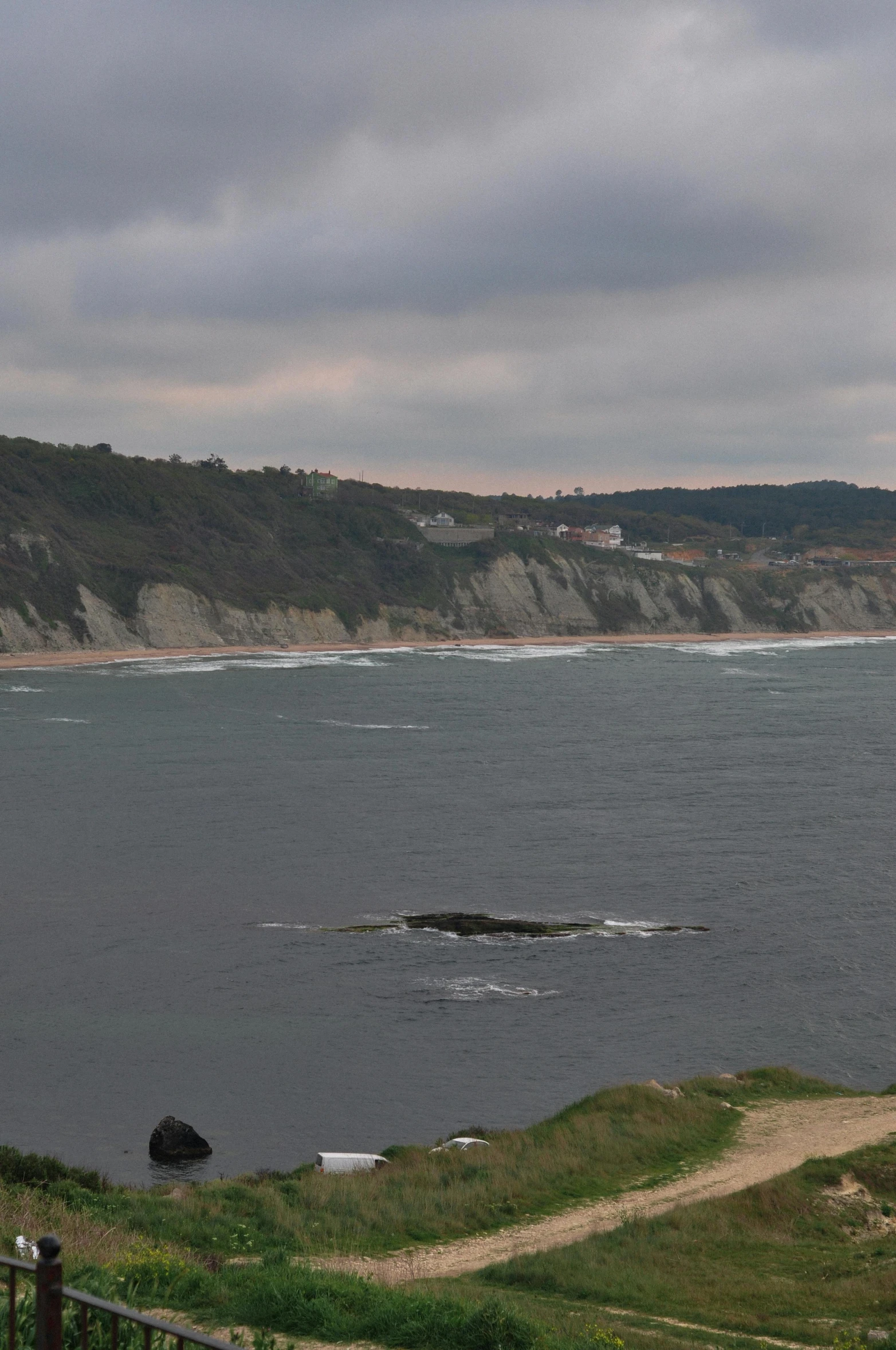 there is a large body of water and houses in the distance