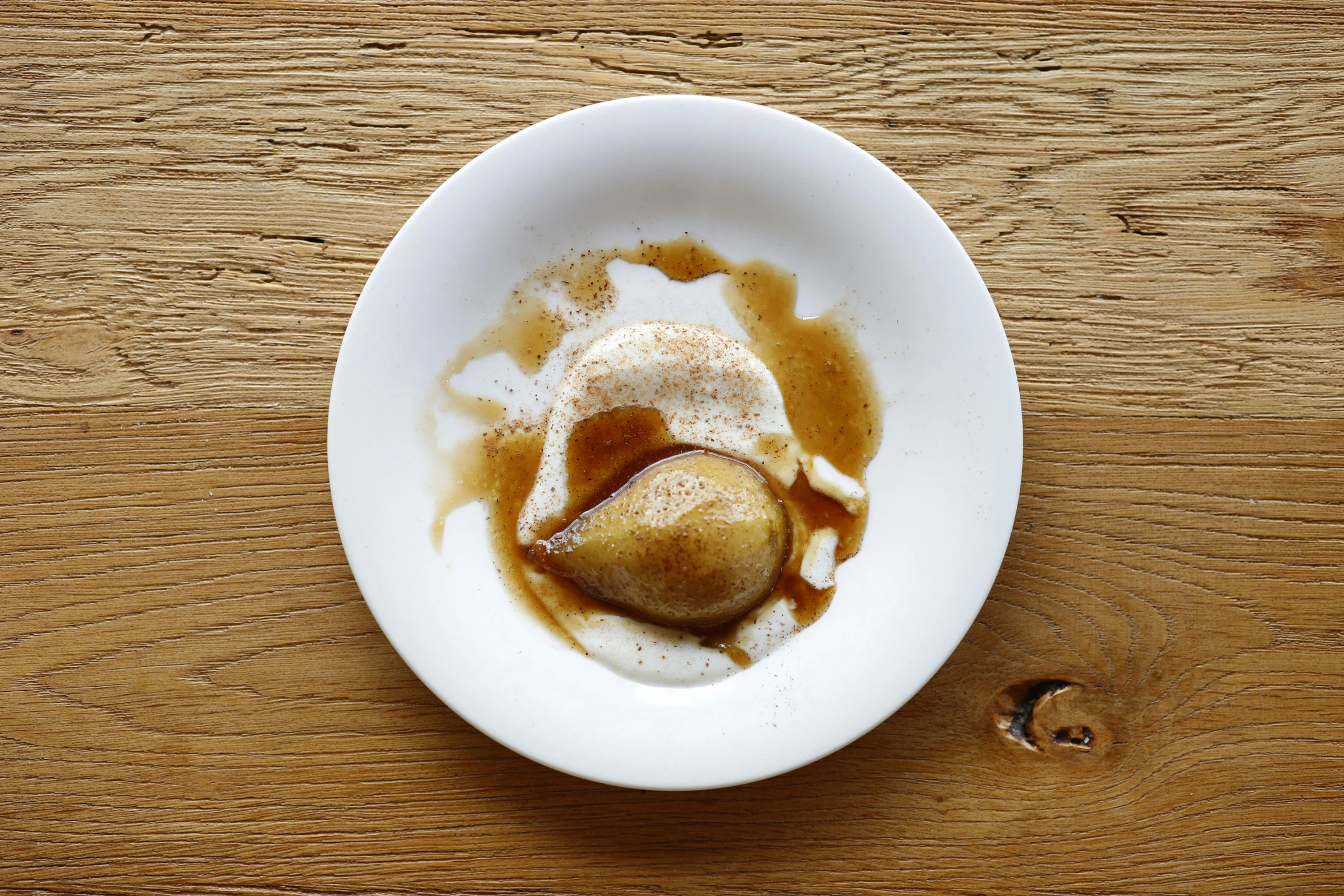 a bowl filled with ice cream on top of a wooden table