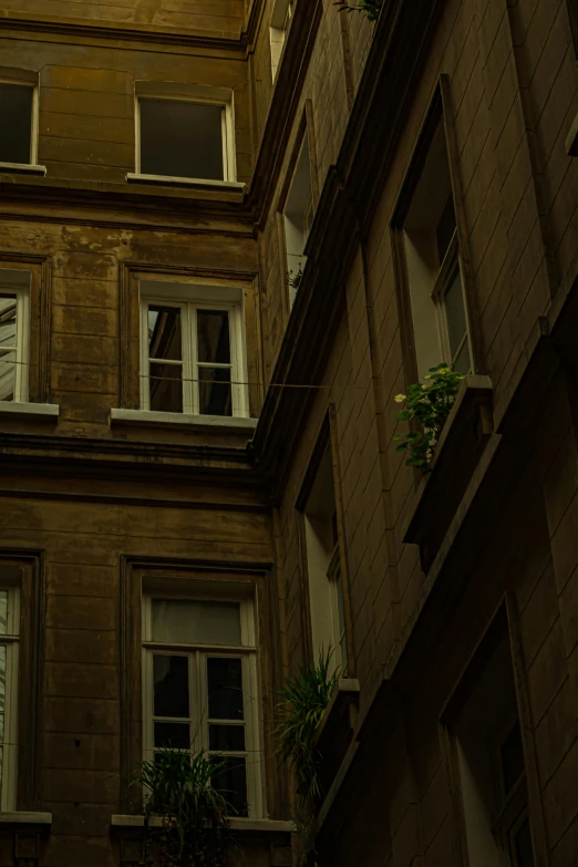 a clock on the side of a building with two windows