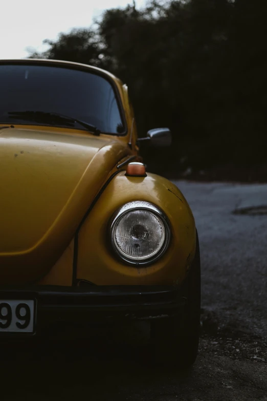 an image of a yellow bug parked on the street